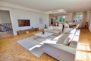a living room with white couches and a table at Exclusive Villa Magnolia Apartment with Private Pool Cannes Center in Cannes