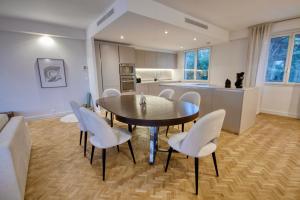 a kitchen and dining room with a table and chairs at Exclusive Villa Magnolia Apartment with Private Pool Cannes Center in Cannes