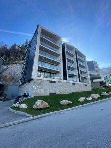 a large building with rocks in front of it at Family Corner Bjelašnica in Bjelašnica