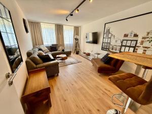 a living room with a couch and a table at Schwebebahn View Apartment in Wuppertal