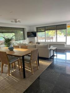 a living room with a wooden table and chairs at Eden Mar Sant Antoni de Calonge in Sant Antoni de Calonge