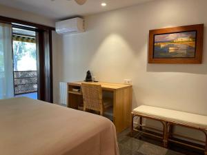 a room with a desk and a bed and a table at Eden Mar Sant Antoni de Calonge in Sant Antoni de Calonge +20 photos