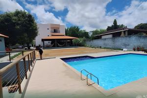 a swimming pool in front of a house at Refuge Aldeia dos Camarás in Camaragibe