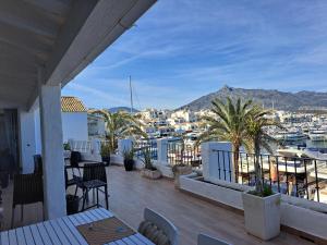 a balcony with a view of a harbor at Huge penthouse with private suites shared terrace and kitchen BEST VIEWS in Marbella