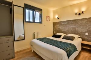 a bedroom with a large bed and a window at CHALET CINEMA - Climatisé- Les Belles Ouvrières in Clermont-Créans +8 photos