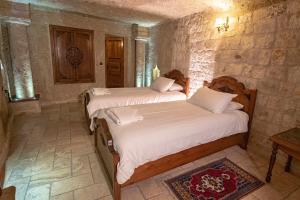 Postel nebo postele na pokoji v ubytování Kemerhan Cave Suites