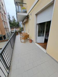 a patio with two benches and a balcony at Da Marco in Parma