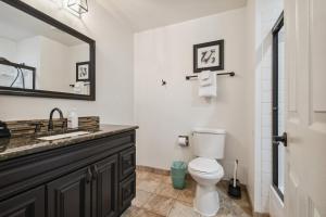 a bathroom with a sink and a toilet and a mirror at 6380 B6-1364 Byte-Sized Studio in Boston Commons in Greenwood Village