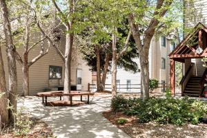 a picnic table in front of a house with trees at 6380 B6-1364 Byte-Sized Studio in Boston Commons in Greenwood Village