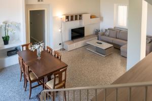 a living room with a table and a dining room at La Villetta Nicolini in Barbaresco