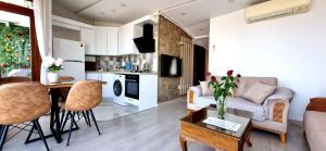 a living room and kitchen with a couch and a table at Taksim Flat in Istanbul