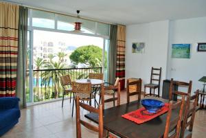 uma sala de jantar com mesa e cadeiras e uma varanda em Carabeo 28 Apartments Casasol em Nerja