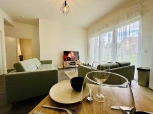 a living room with a couch and a table at Horizon House - Roissy CDG - Parc des Expos in Villepinte