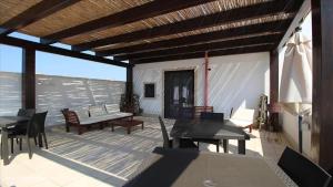 a patio with tables and chairs on a deck at Spacious House Near the Beach in San Pietro in San Pietro in Bevagna
