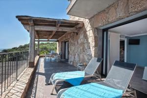 a room with a view of the balcony of a house at Appartement avec vue sur la mer à Olmeto in Olmeto