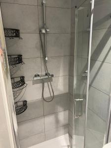 a bathroom with a shower with a glass door at Coastal Charm and Tranquility in our Studio Guest House in Bournemouth +29 photos