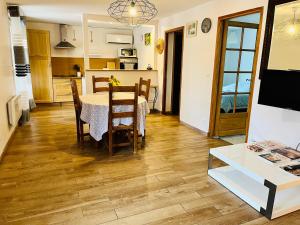 a kitchen and dining room with a table and chairs at House with nice garden, downtown by walk in Vaison-la-Romaine