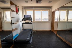 プラハにあるLuxury rooftop appartment with fantastic viewsの窓とノートパソコン付きの客室で、トレッドミルが備わります。