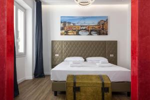 a bedroom with a bed with a painting on the wall at Corte dell'Albero in Florence