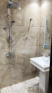 a bathroom with a sink and a shower at ايريس لايف Iris Life Hotel in Jeddah +31 photos