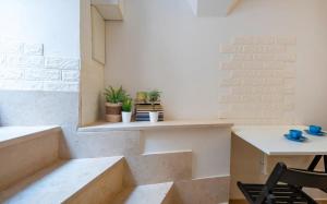 a room with stairs and a table and chairs at Giù in centro in Putignano