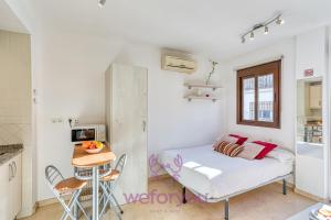 a small bedroom with a bed and a table at weforyou Old Town Benalmadena in Benalmádena +26 photos