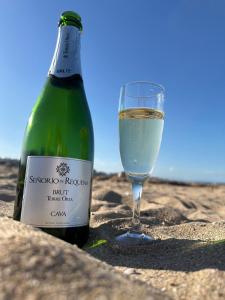 a bottle of wine and a glass on the beach at Los Locos Luxury in Torrevieja
