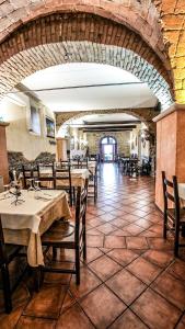 a restaurant with tables and chairs in a room at Casale Colle dell'Asino in Ciampino
