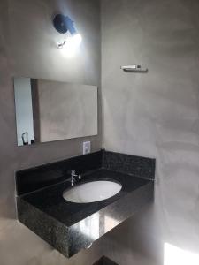 a bathroom with a sink and a mirror at Rio Quente - Pousada do Charme in Rio Quente +40 photos