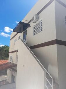 a white building with a staircase on the side at Rio Quente - Pousada do Charme in Rio Quente