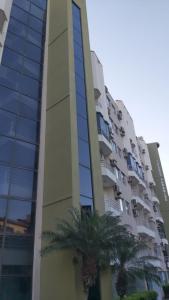 a tall building with palm trees in front of it at Rio Quente Thermas Paradise in Rio Quente +17 photos