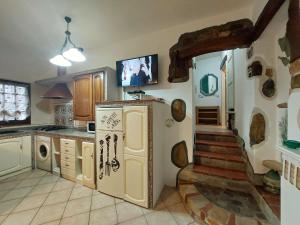 a kitchen with a staircase leading up to a room at two-room apartment with parking space in Rio nellʼElba +10 photos