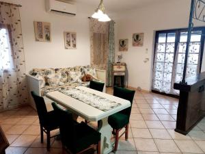 a living room with a table and a couch at two-room apartment with parking space in Rio nellʼElba