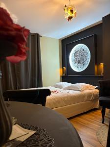 a bedroom with a bed and a poster of a moon at Votre expérience insolite - Clair de lune in Caen +10 photos