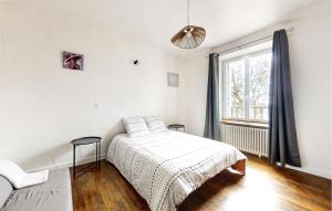 a white bedroom with a bed and a window at 3 Bedroom Beautiful Home In Pont-Aven in Pont-Aven
