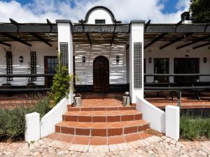 an old house with a front door and stairs at Dunkes Organic Equestrian Estate in George