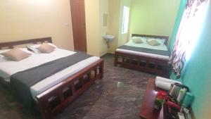 Postel nebo postele na pokoji v ubytování Karthik Residency Thiruvannamalai