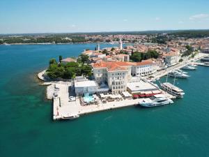an aerial view of a marina with boats in the water at BO Hotel Palazzo in Poreč