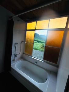 a bath tub in a bathroom with a window at Nodriza House in Baeza