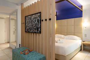 a bedroom with a bed and a blue ceiling at Royal Antibes - Luxury Hotel, Résidence, Beach & Spa in Antibes