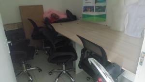 a room with a table with chairs and a box at Homestay syariah off in Karawang