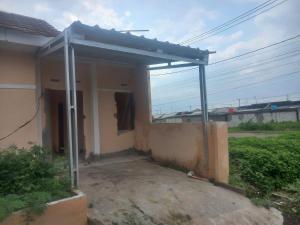 a house with a metal roof on the side of it at Homestay syariah off in Karawang