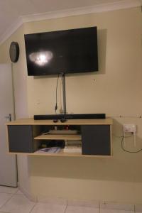 a flat screen tv on top of a shelf at Zone 4 Motel in Polokwane