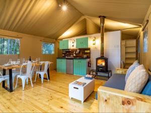 a living room with a couch and a table at AfriCamps at Bonamanzi Game Reserve in Hluhluwe