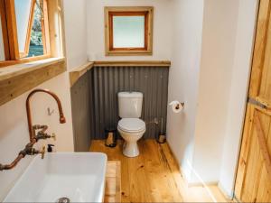 a bathroom with a toilet and a sink and a window at AfriCamps at Bonamanzi Game Reserve in Hluhluwe +19 photos