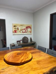 a large wooden table in a room with chairs at Paraíso no Velho Chico in Canindé de São Francisco