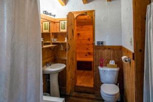 a bathroom with a toilet and a sink at Edelweiss Inn Nova Scotia in Middleton +165 photos