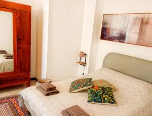 a bedroom with a bed with two pillows on it at La Casa del Belvedere in Perugia