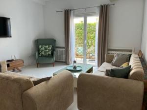 a living room with two couches and a table and a chair at Very high standing apartment in Gammarth