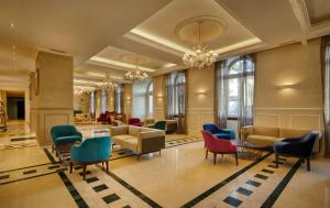 a lobby with chairs and tables in a building at BO Hotel Palazzo in Poreč